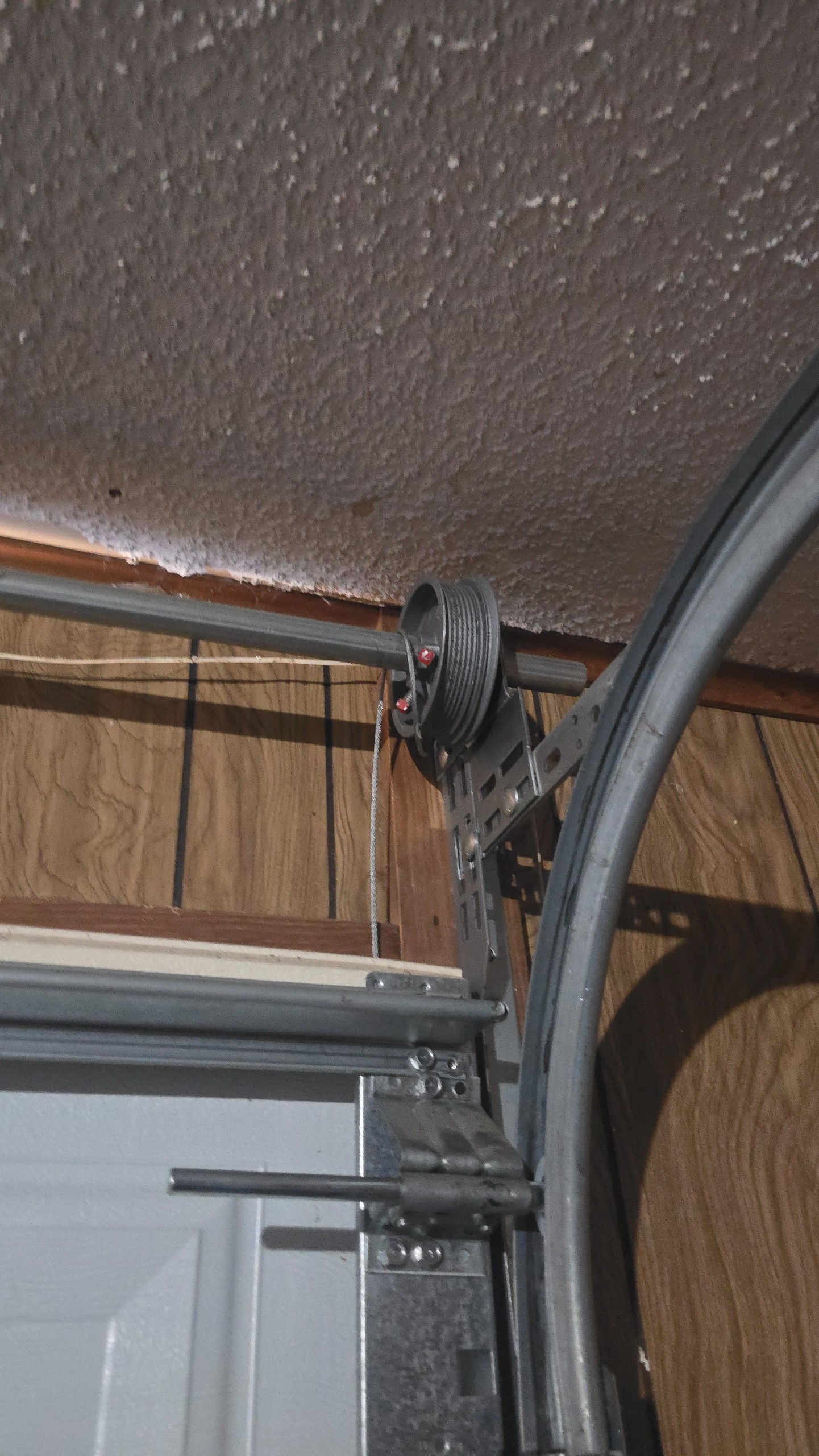 Lift cable displaced from the garage door drum onto the torsion shaft in Longview, TX