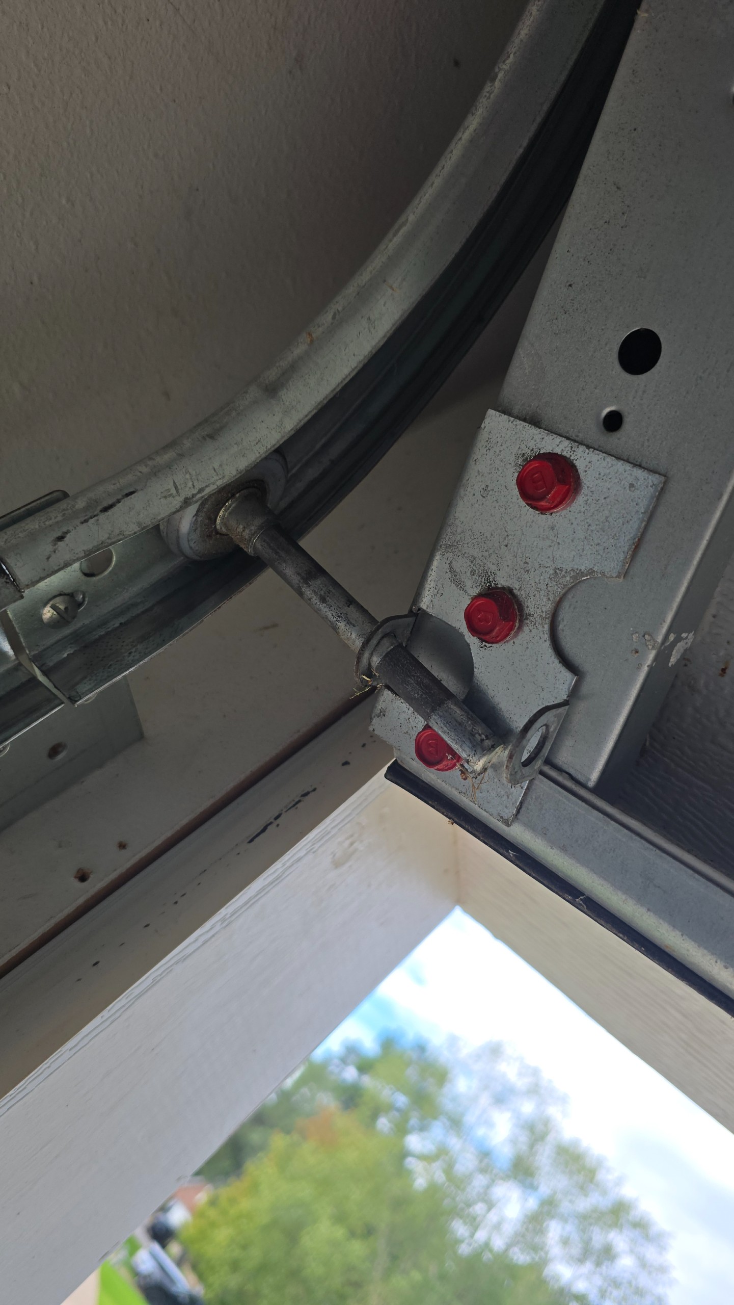 Garage door bottom roller and bracket near the curved track in Tyler, TX