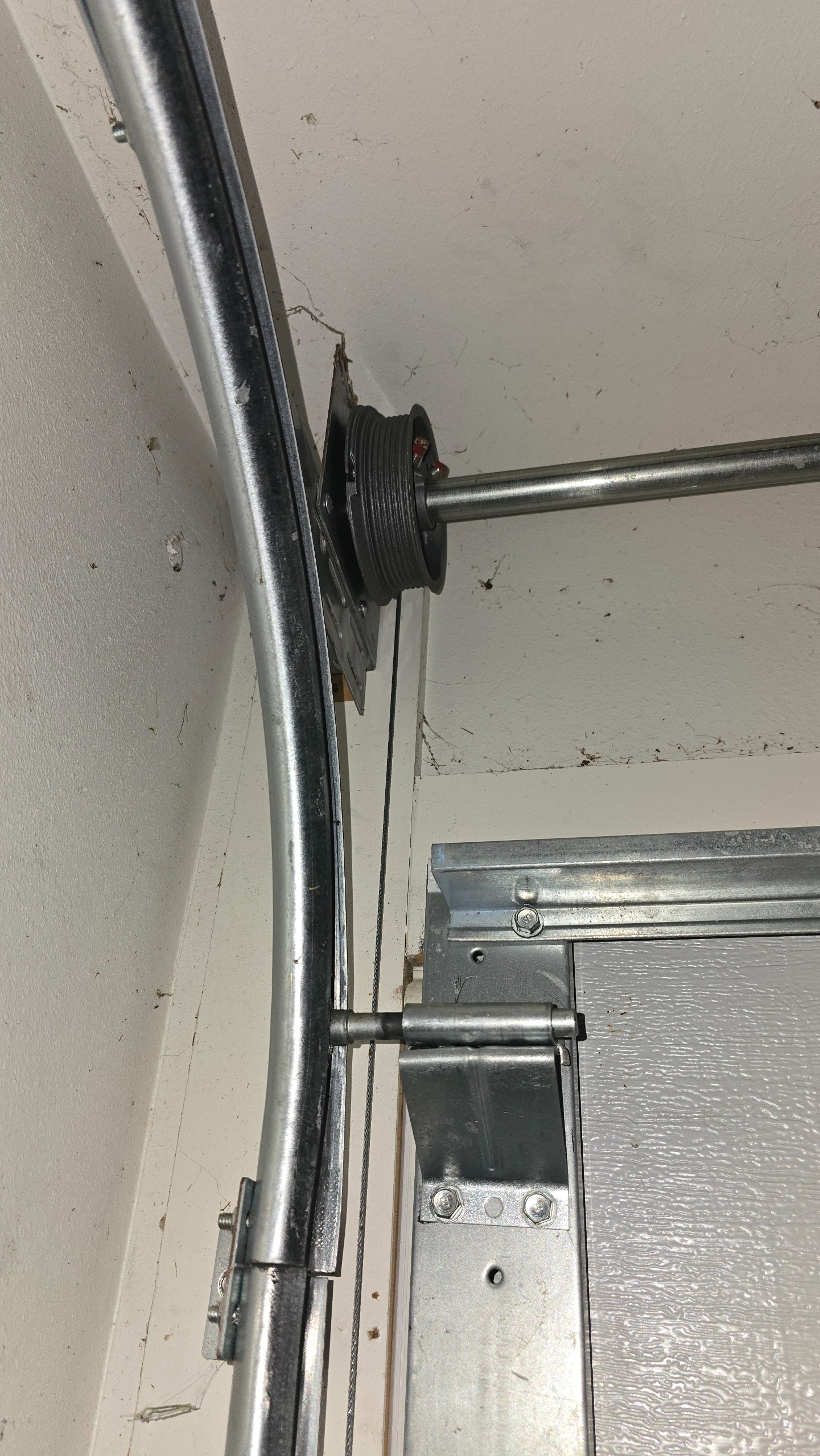 Upper garage door roller bracket, track, lift cable, and cable drum in Tyler, TX