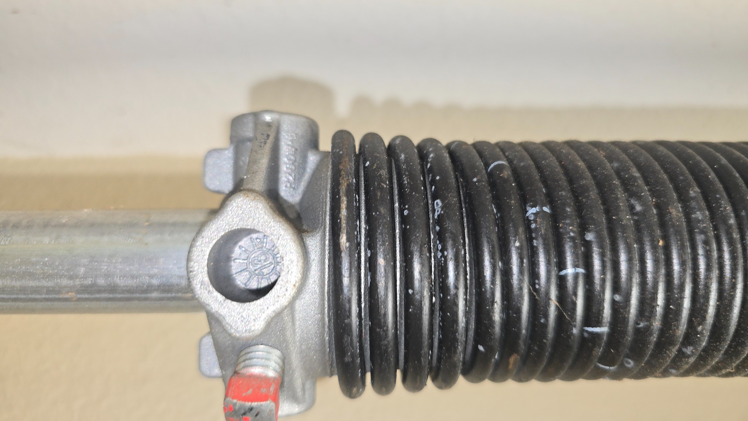Close view of a garage door torsion spring and winding cone in Tyler, TX