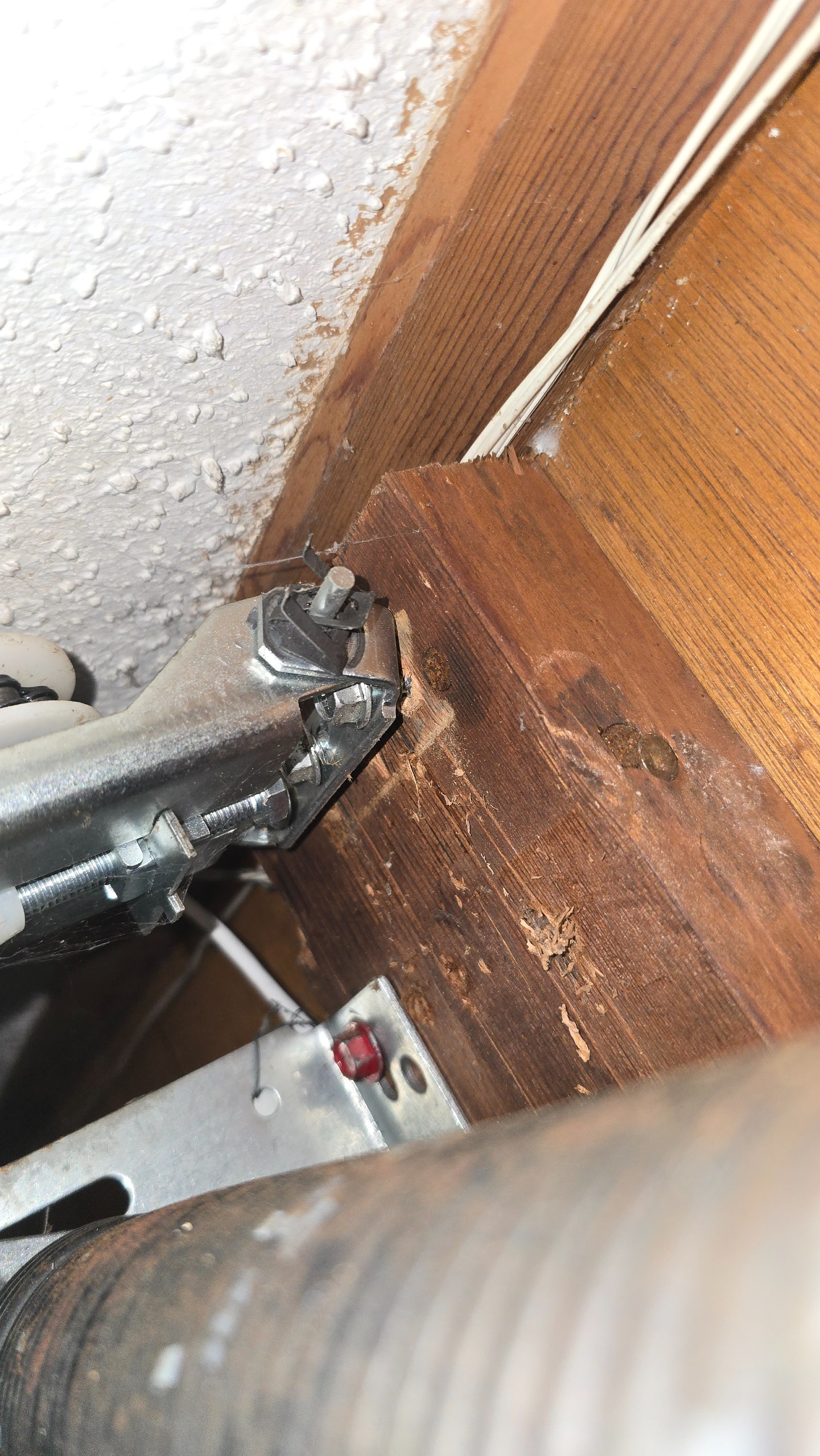 Loose opener rail mounting bracket pulling away from the wooden mounting surface in Longview, TX