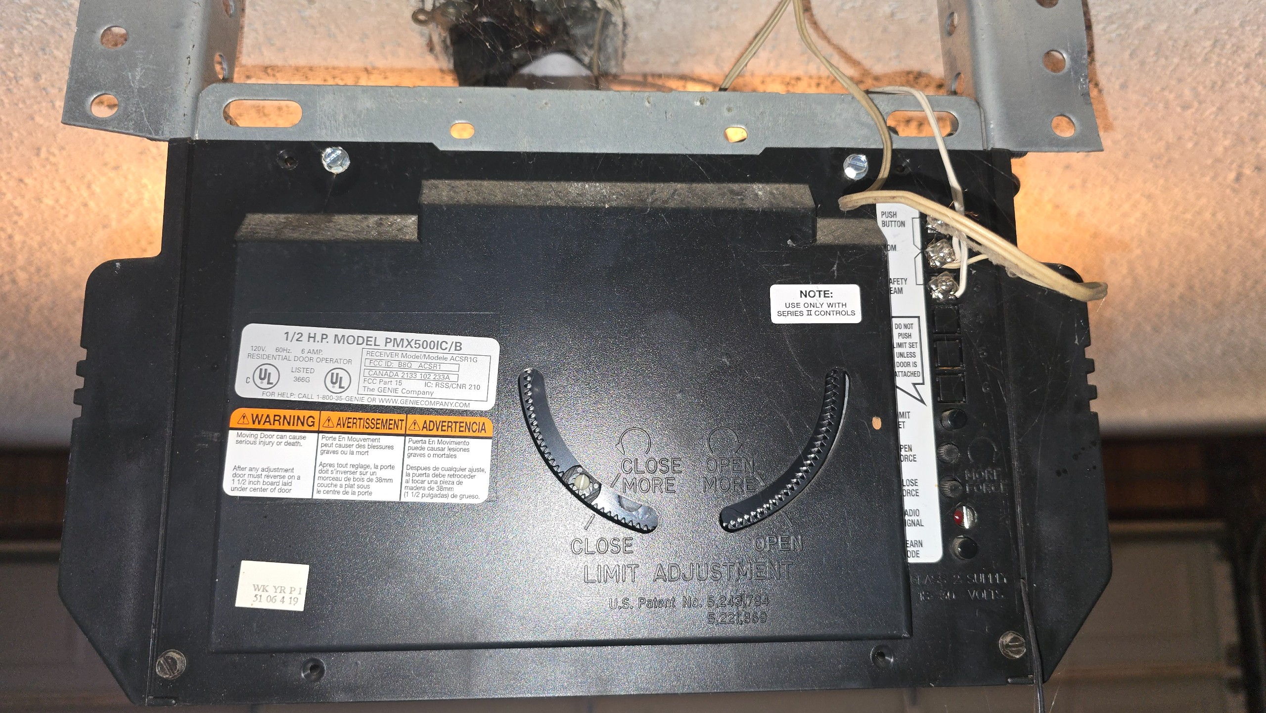 Genie garage door opener showing travel-limit adjustment controls before service in Longview, TX